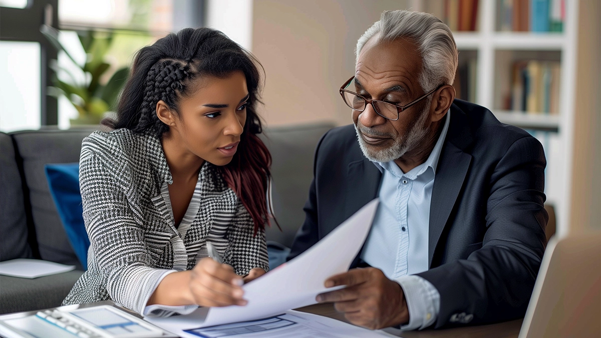 2026 02 25 Older father looking over documents with his daughter