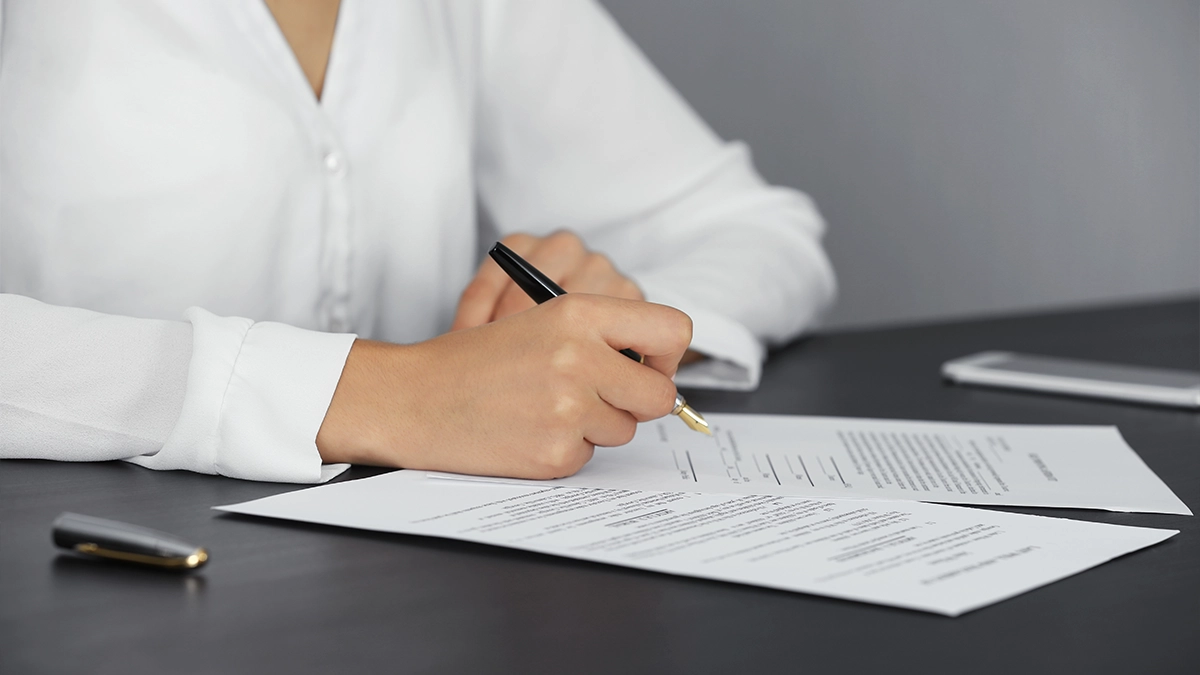 Woman signing last will and testament, closeup Downloaded Woman signing last will and testament